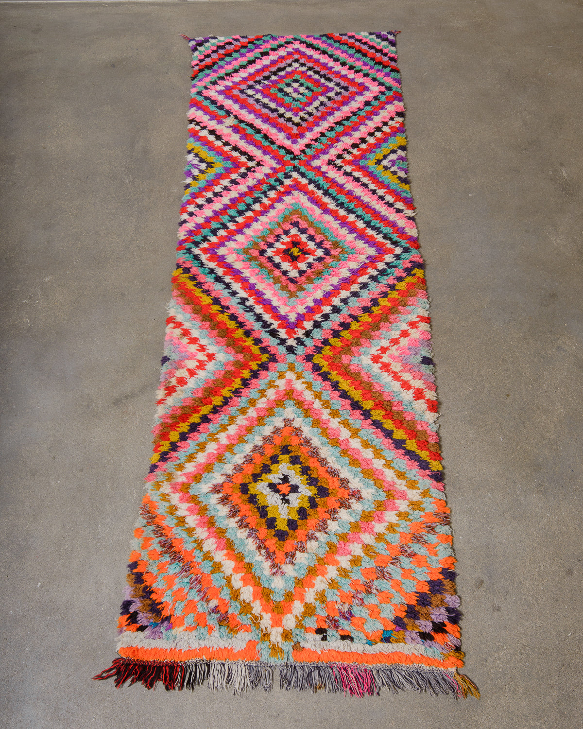 Colorful geometric-patterned rug on a concrete floor